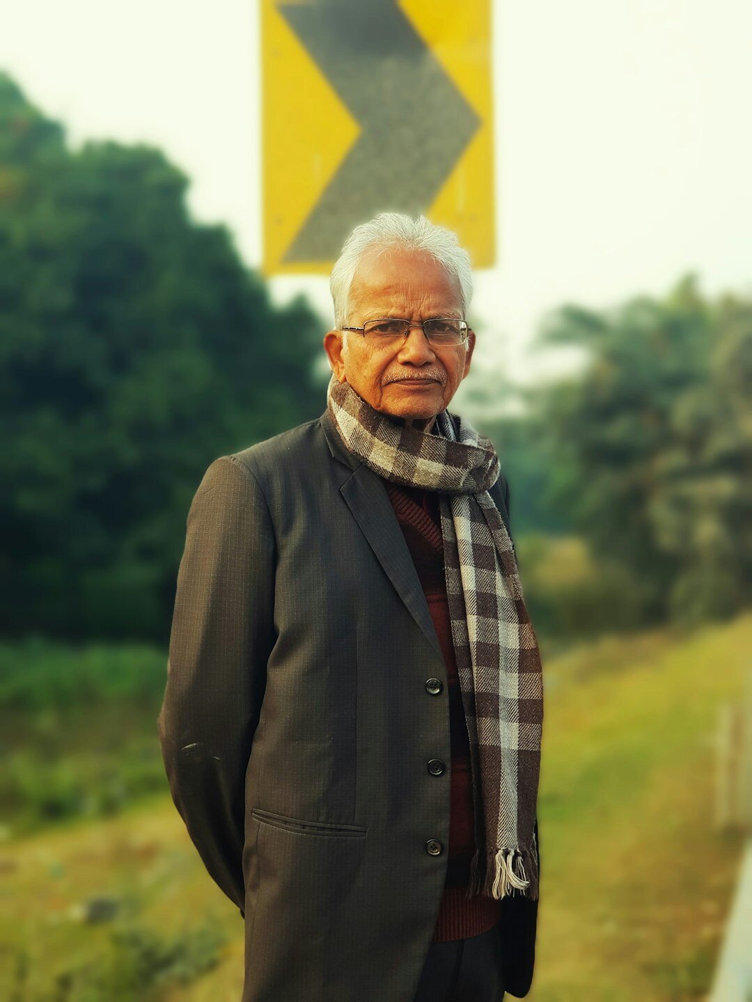 Portrait of a smiling senior Asian man in a blazer