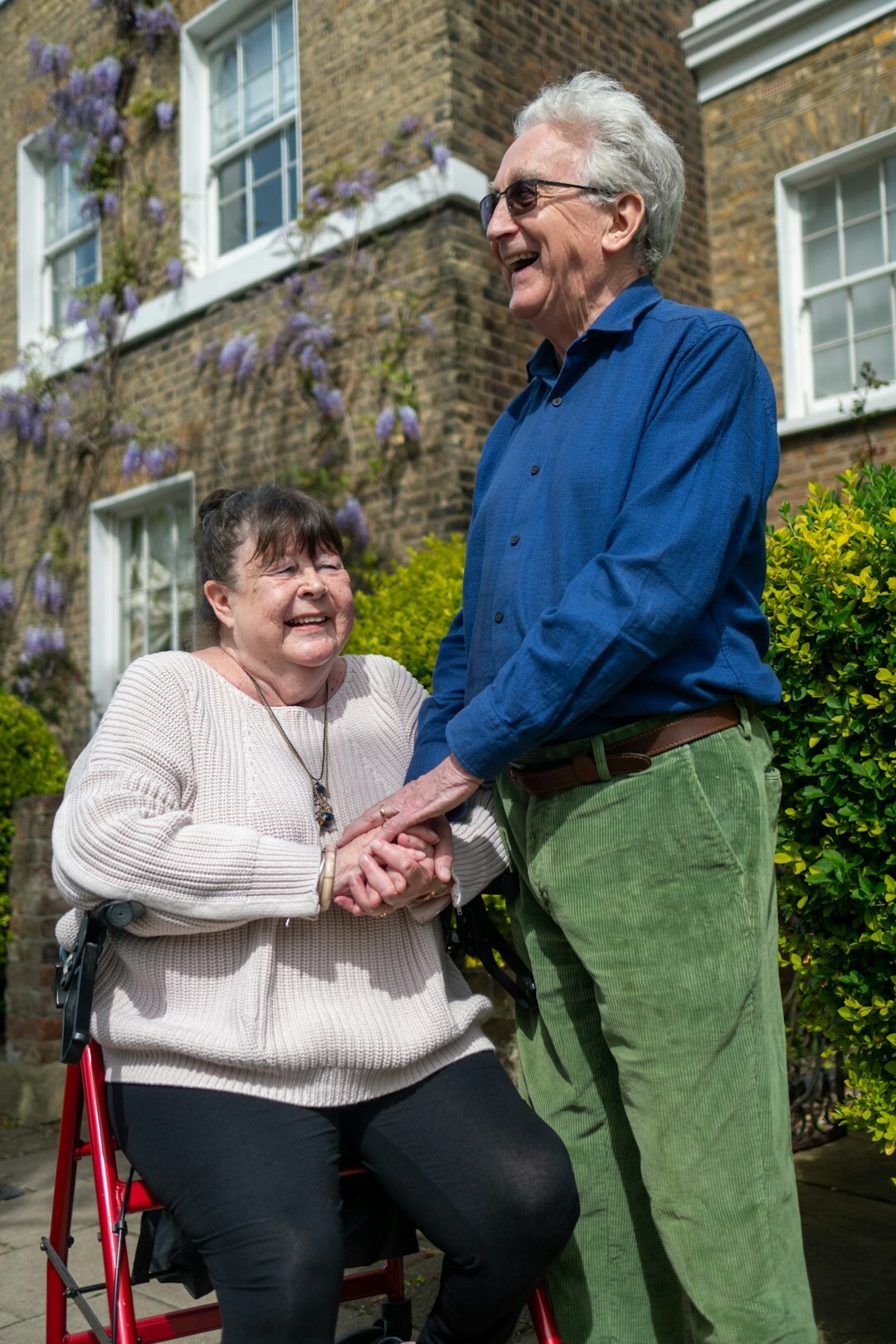 Caregiver staff helping a senior woman walk