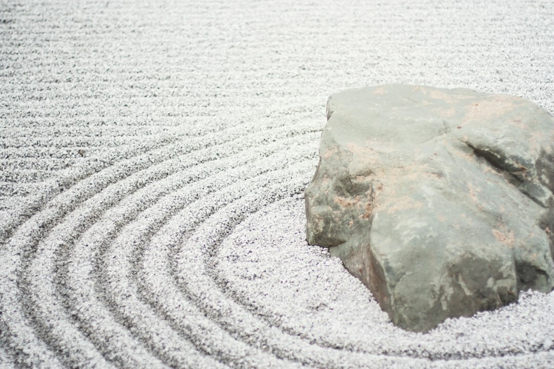Traditional Japanese zen garden with raked sand and rocks
