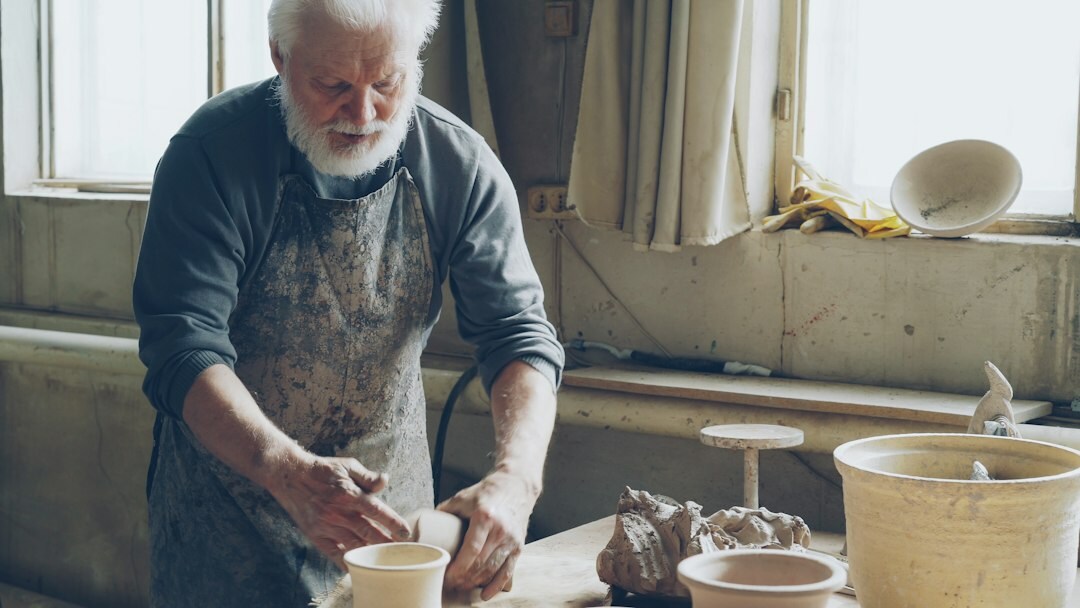 Senior man teaching a pottery workshop